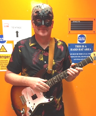 Andy with mask and guitar at Barbican, Royal Shakespeare Company.